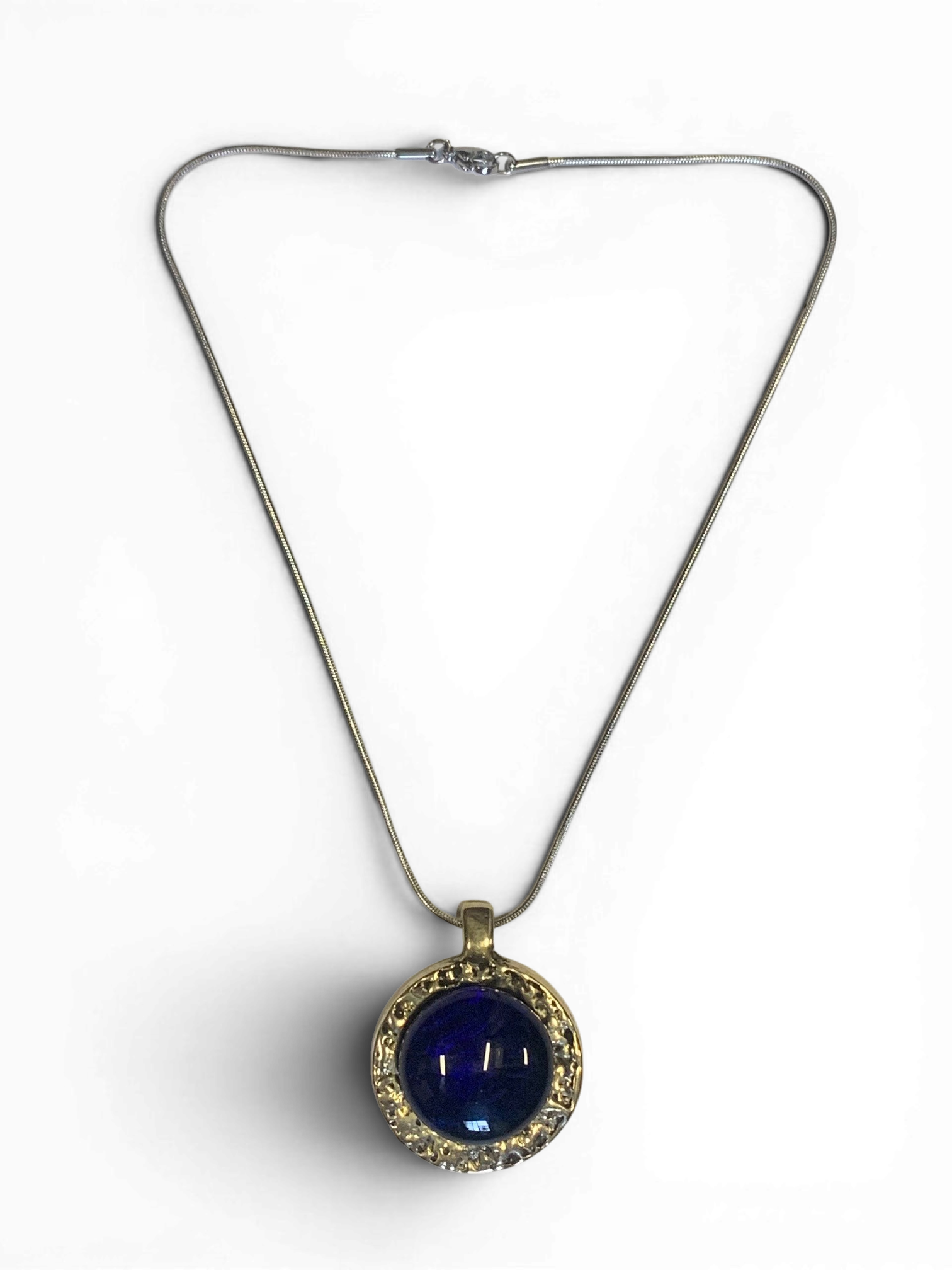 Bronze pendant with deep blue custom-made glass insert
