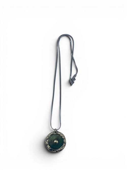 Bronze pendant with green quartz insert