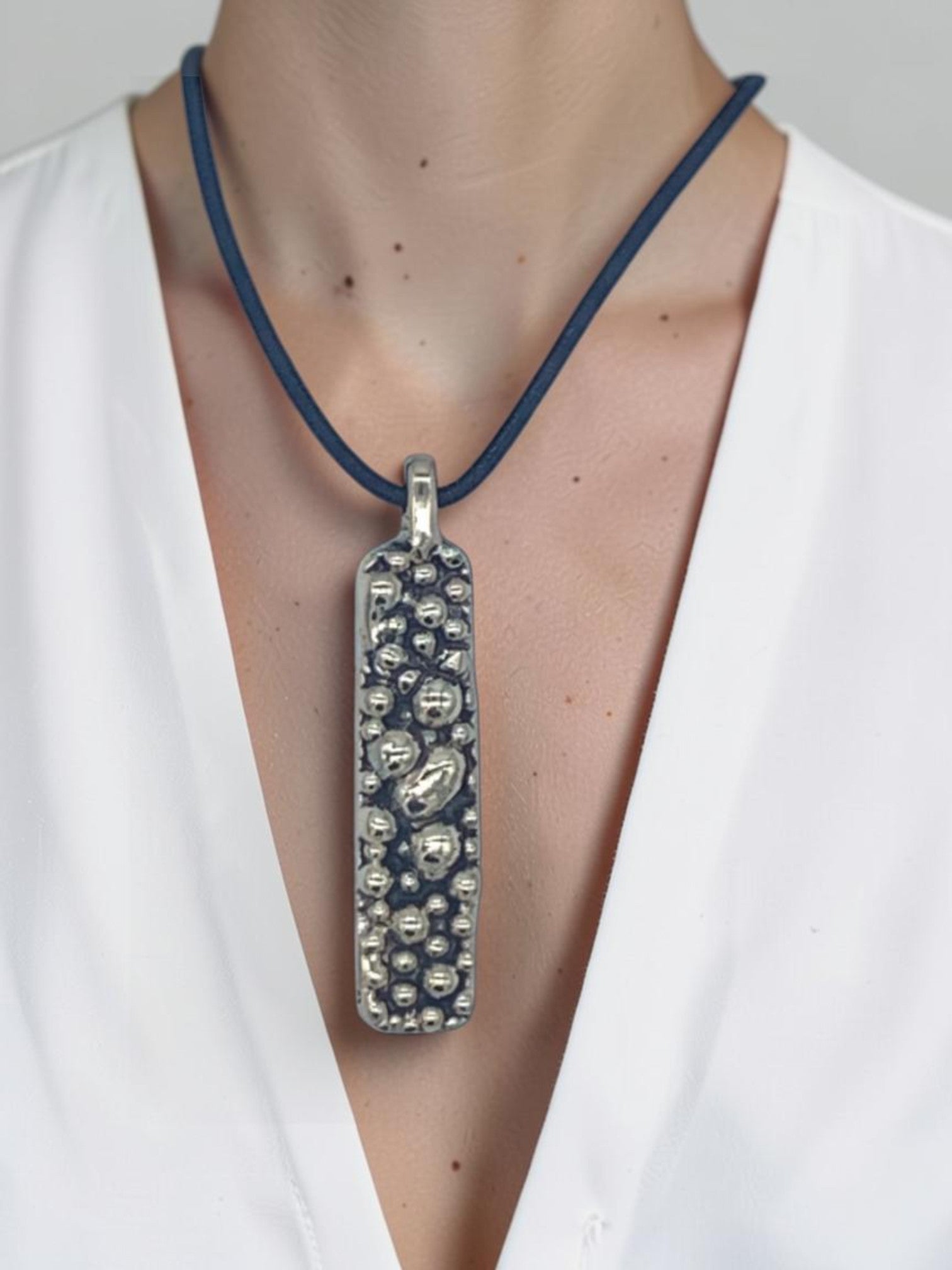 Bronze pendant with round texturized surface