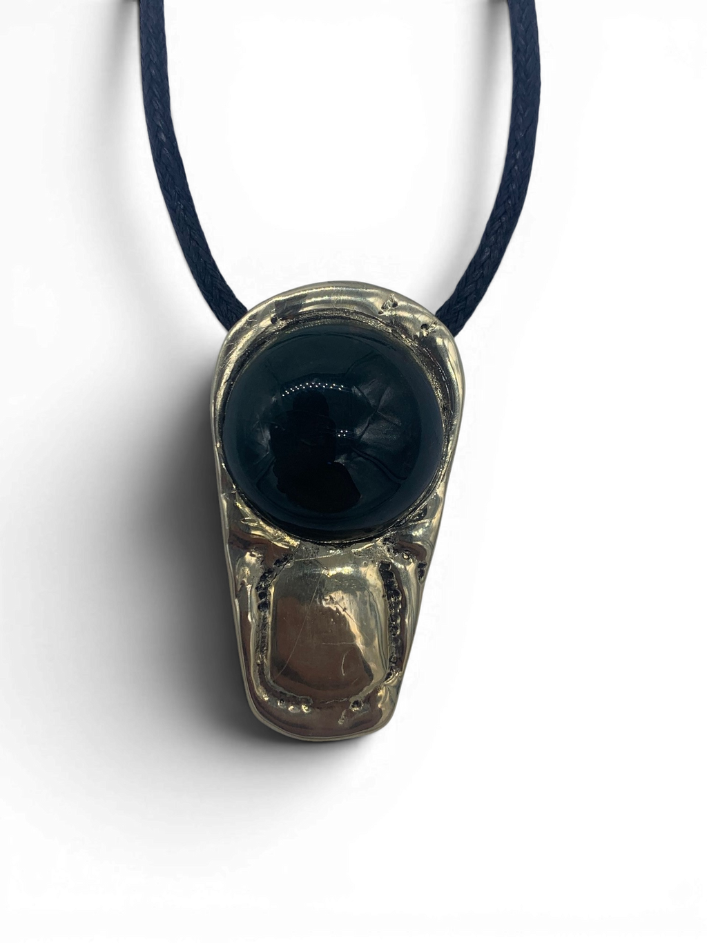 Bronze pendant with obsidian stone insert