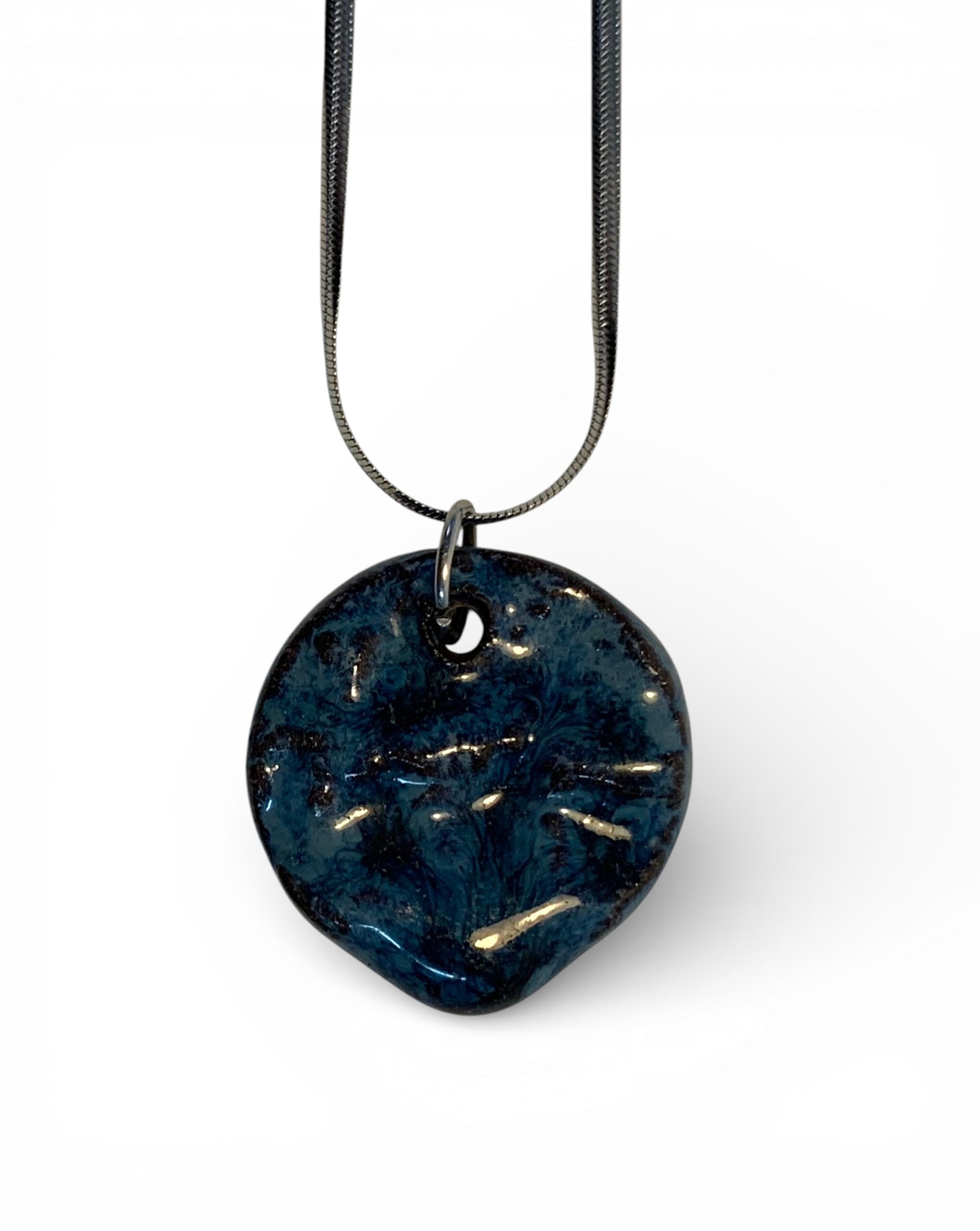 Ceramic pendant with stainless steel chain.