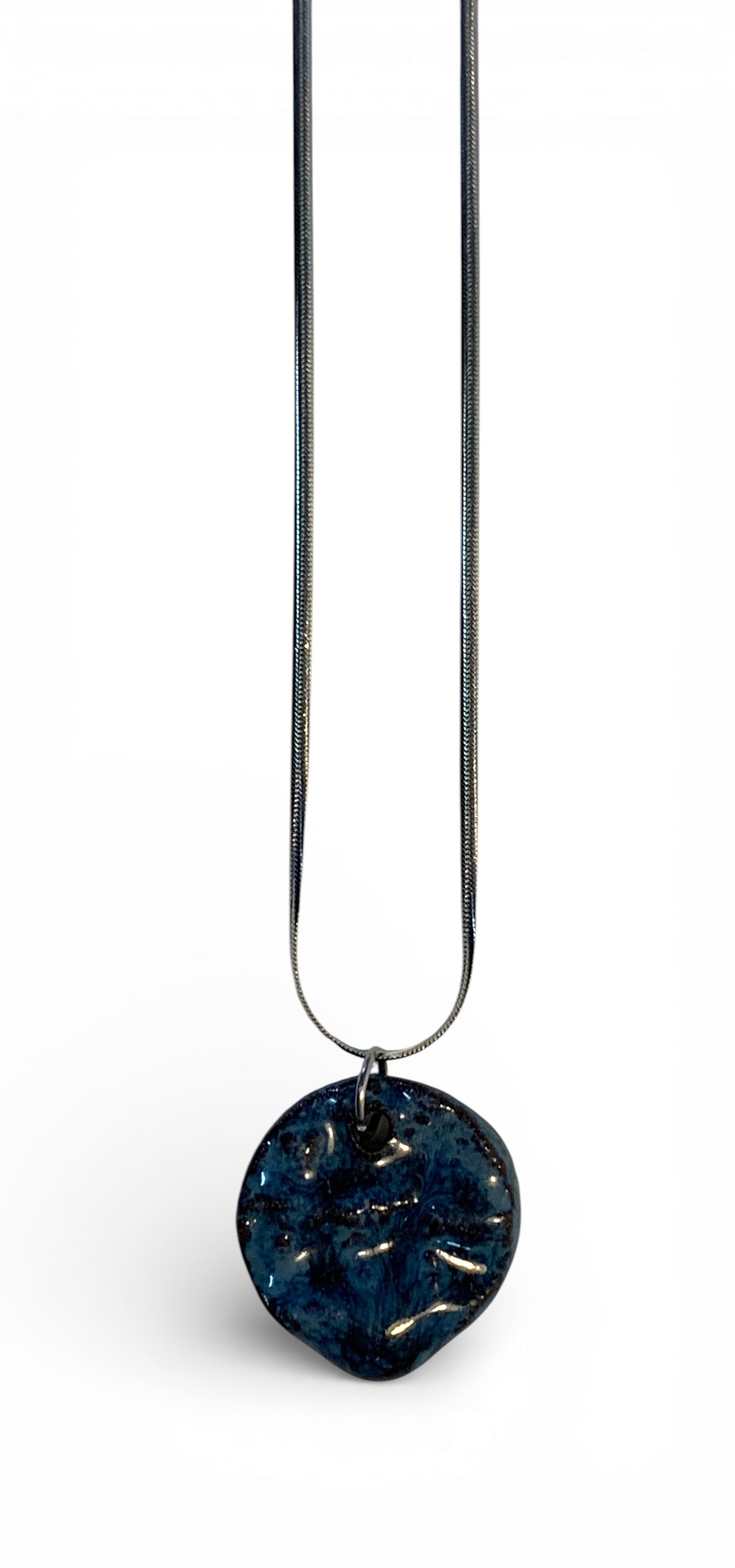 Ceramic pendant with stainless steel chain.