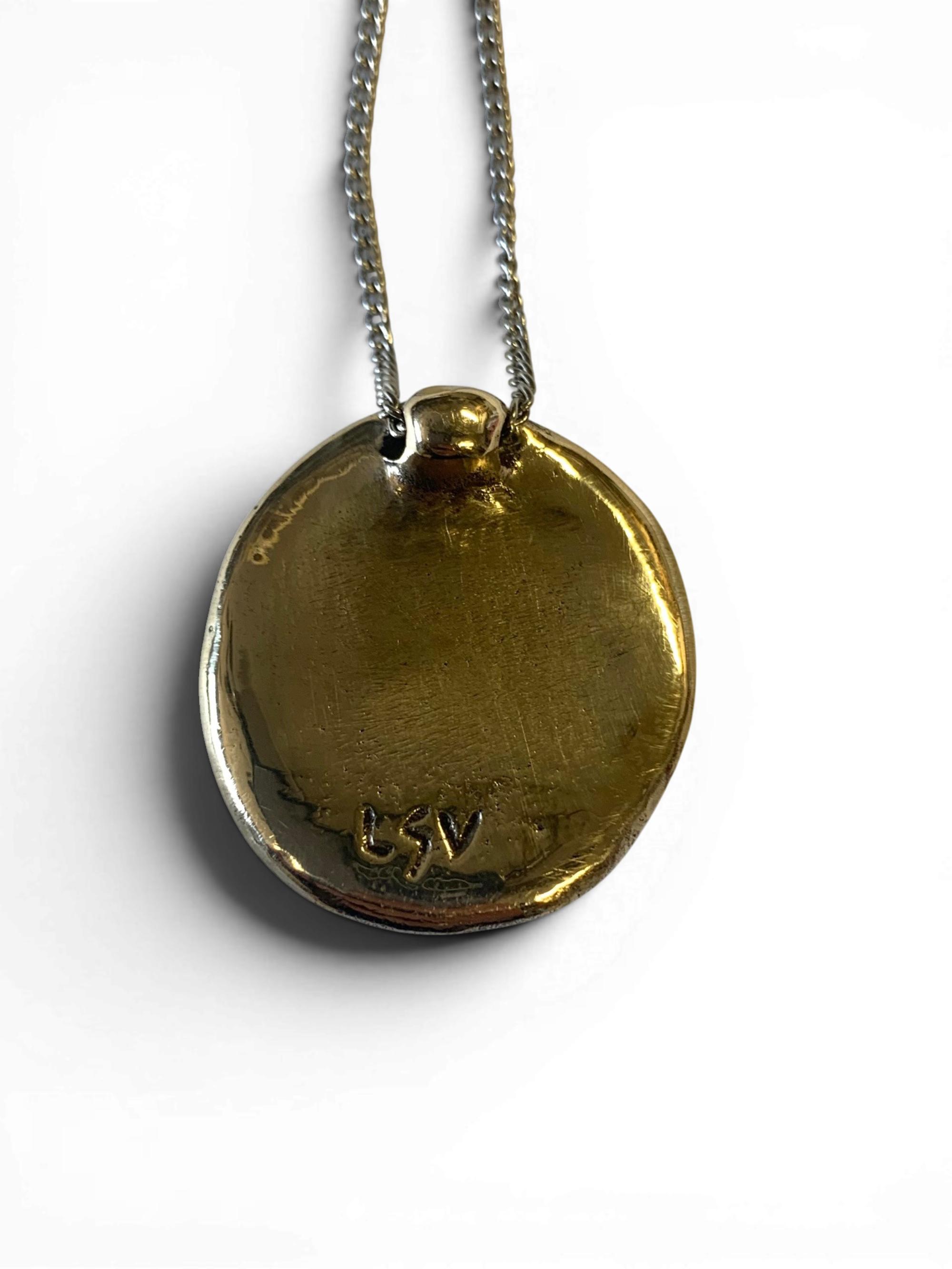 Bronze pendant with red agate insert