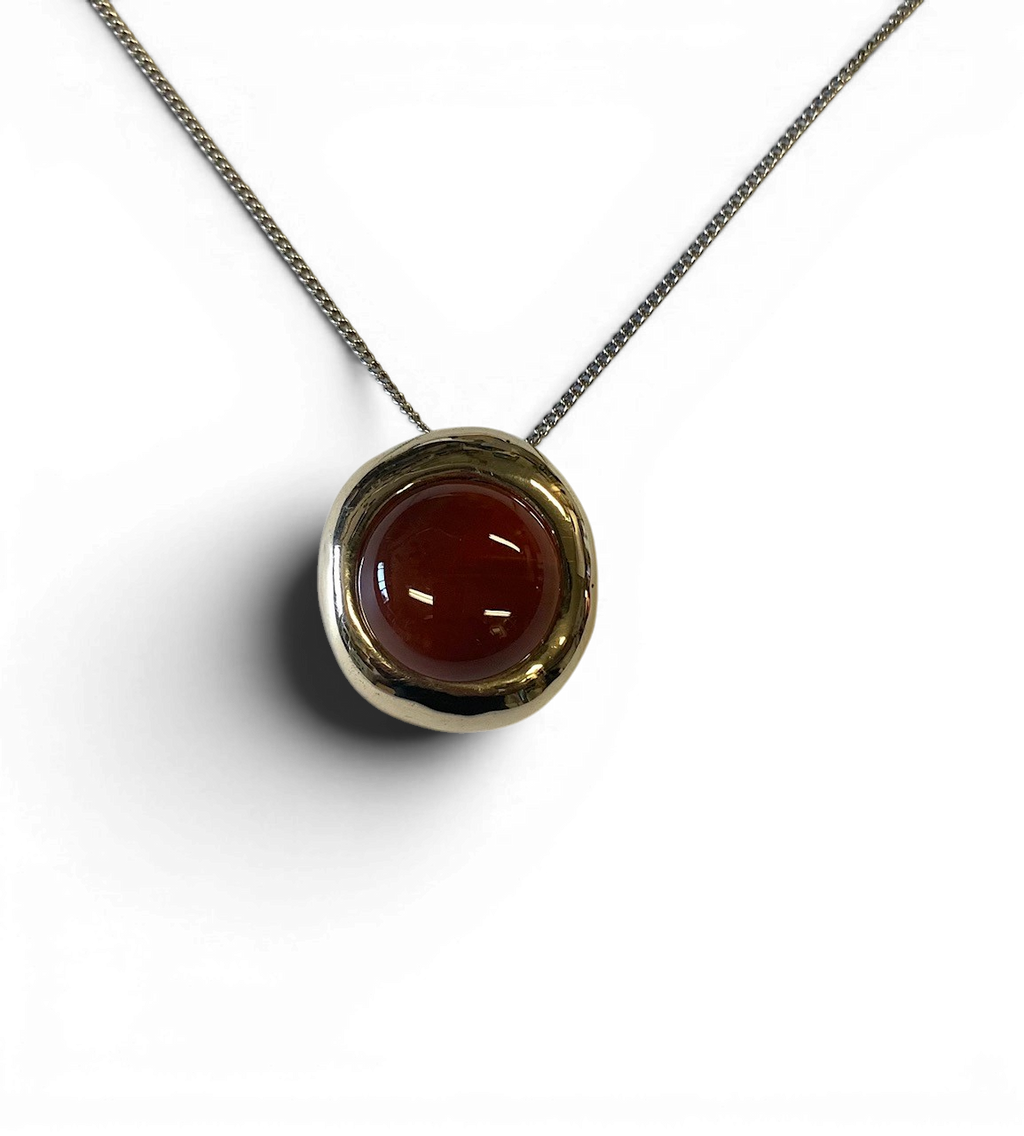 Bronze pendant with red agate insert