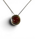 Bronze pendant with red agate insert