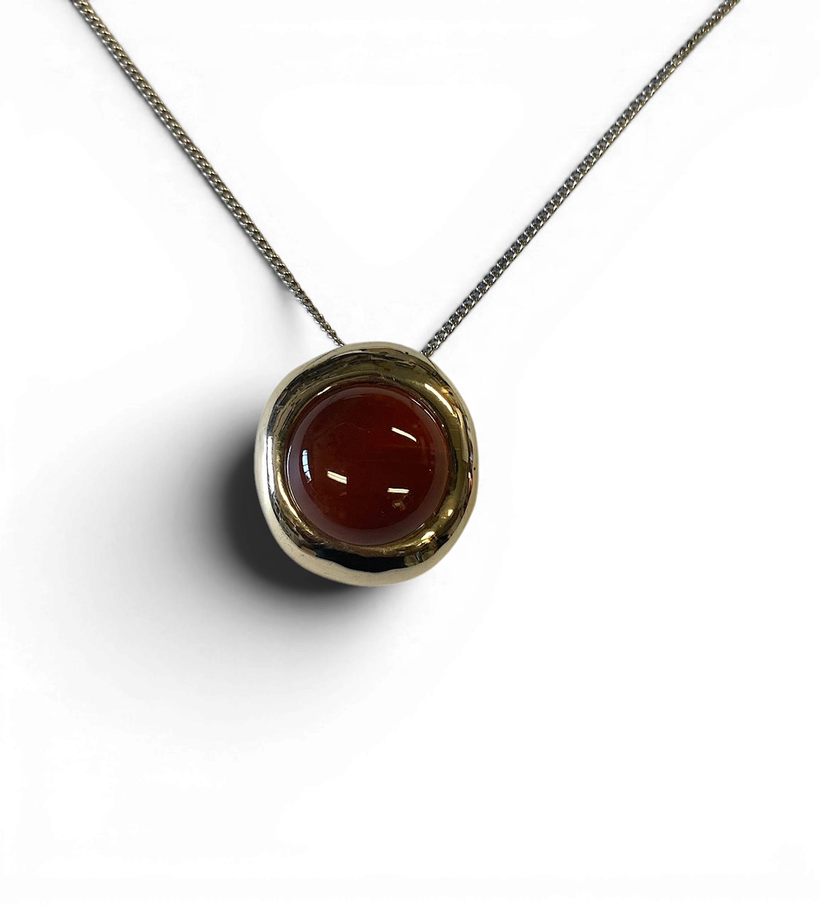 Bronze pendant with red agate insert