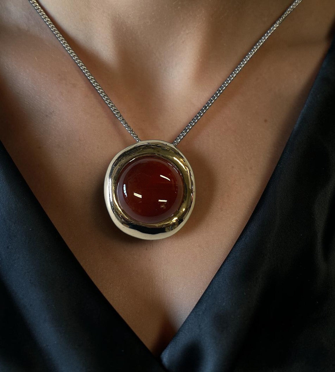 Bronze pendant with red agate insert