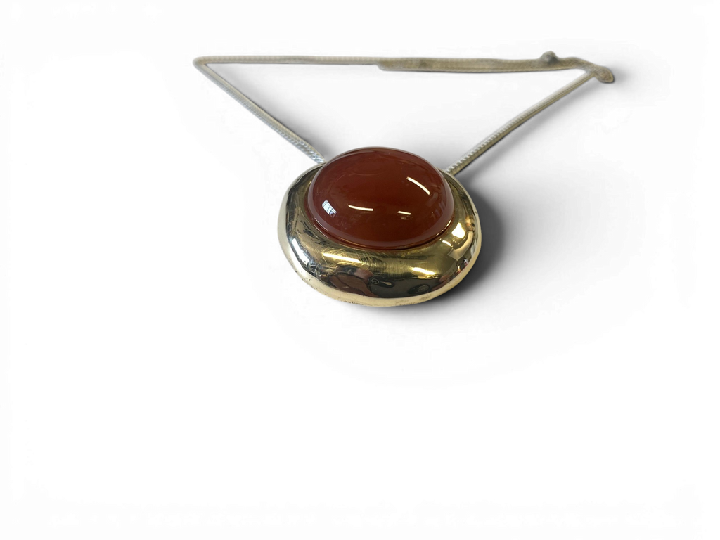 Bronze pendant with red agate insert