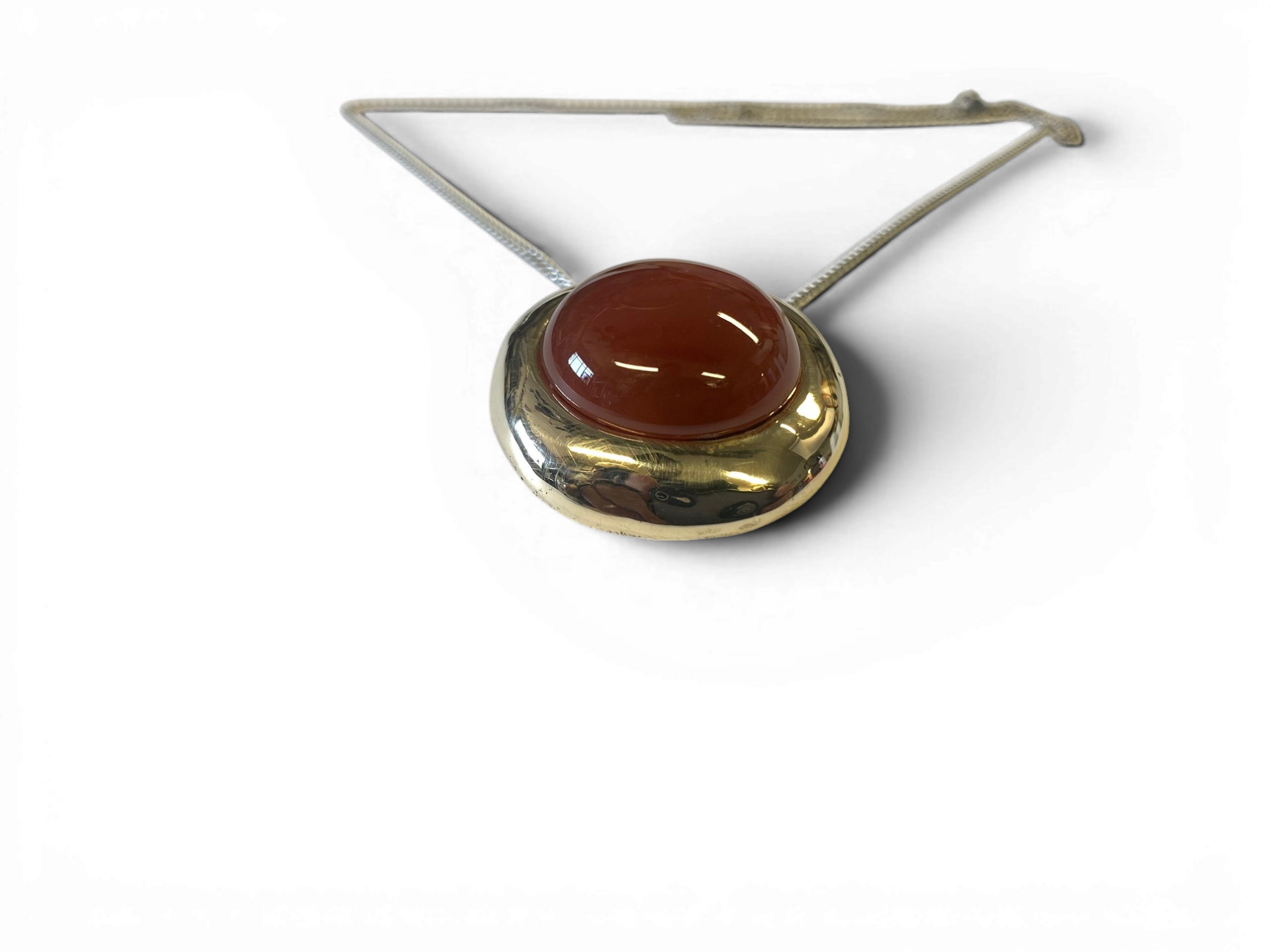 Bronze pendant with red agate insert