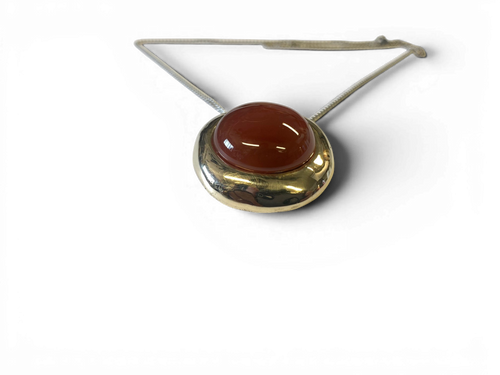 Bronze pendant with red agate insert