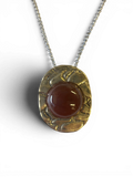 Bronze pendant with red agate insert
