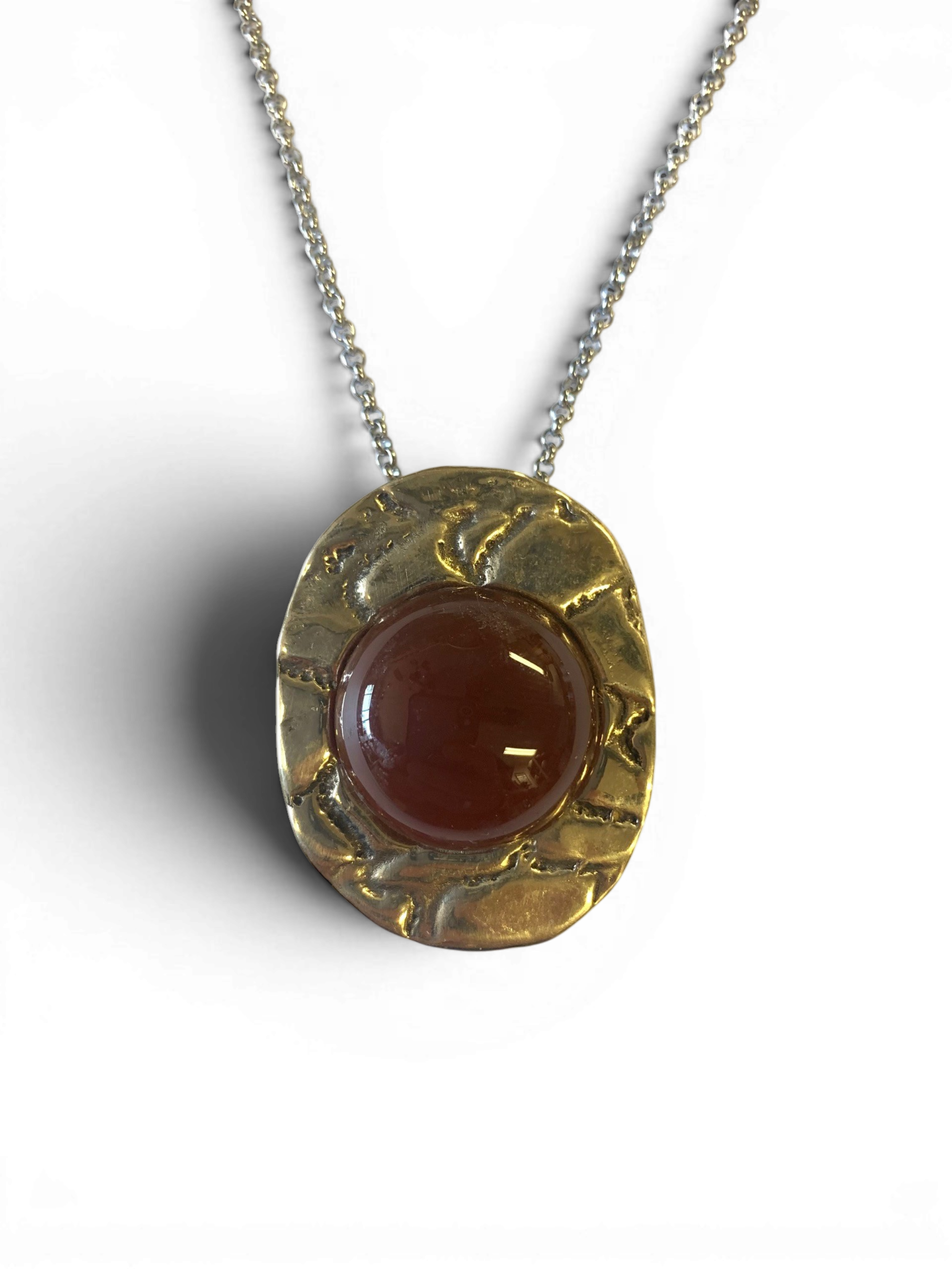 Bronze pendant with red agate insert