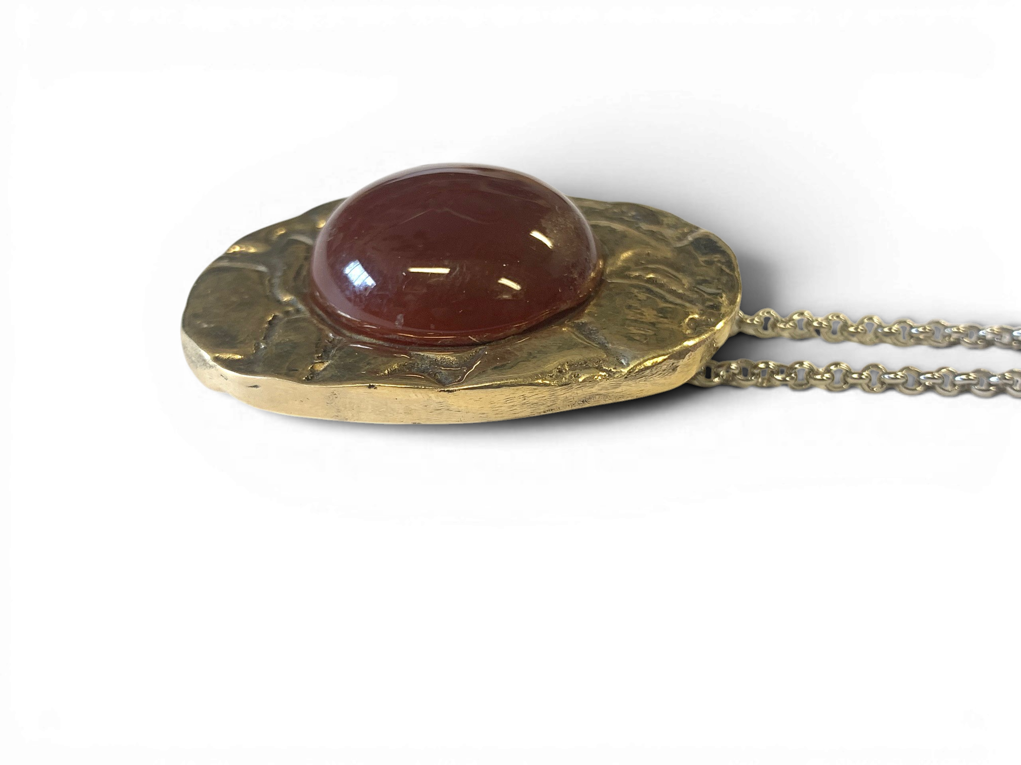 Bronze pendant with red agate insert