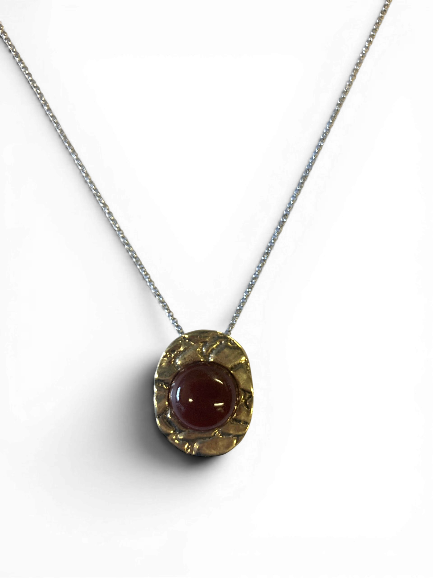 Bronze pendant with red agate insert
