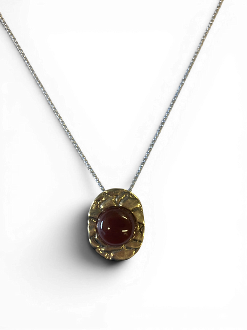 Bronze pendant with red agate insert