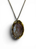 Oval bronze pendant with rock crystal insert