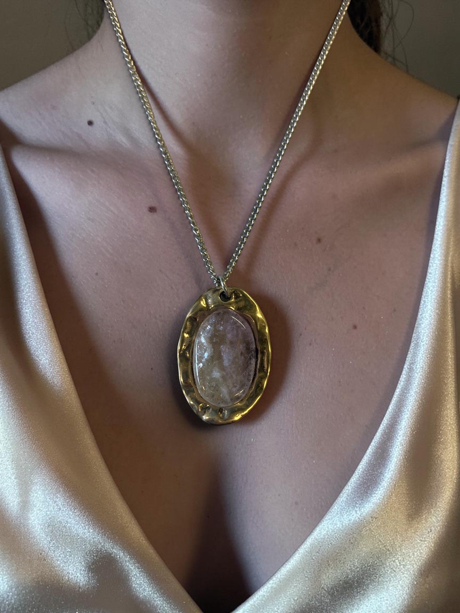 Oval bronze pendant with rock crystal insert