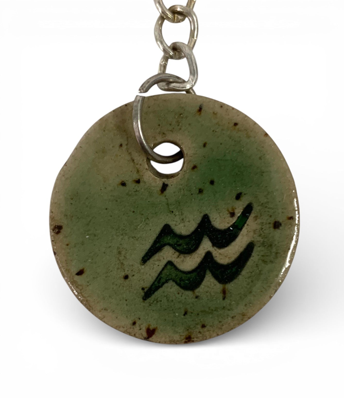 Hand-made ceramic key chain with enamel and sodiac symbols