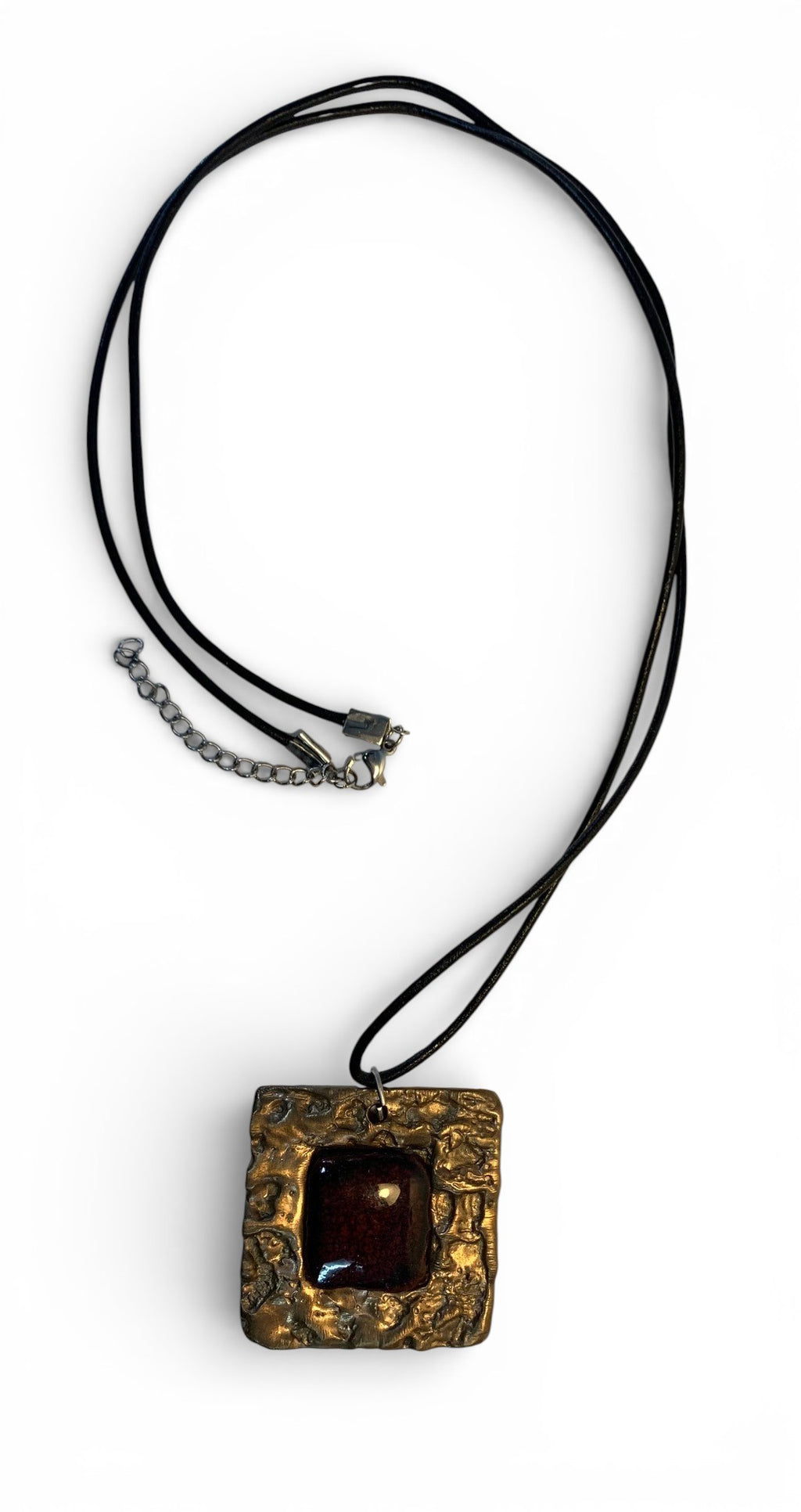 Bronze pendant with texturized surface and agate stone insert and leather chain.