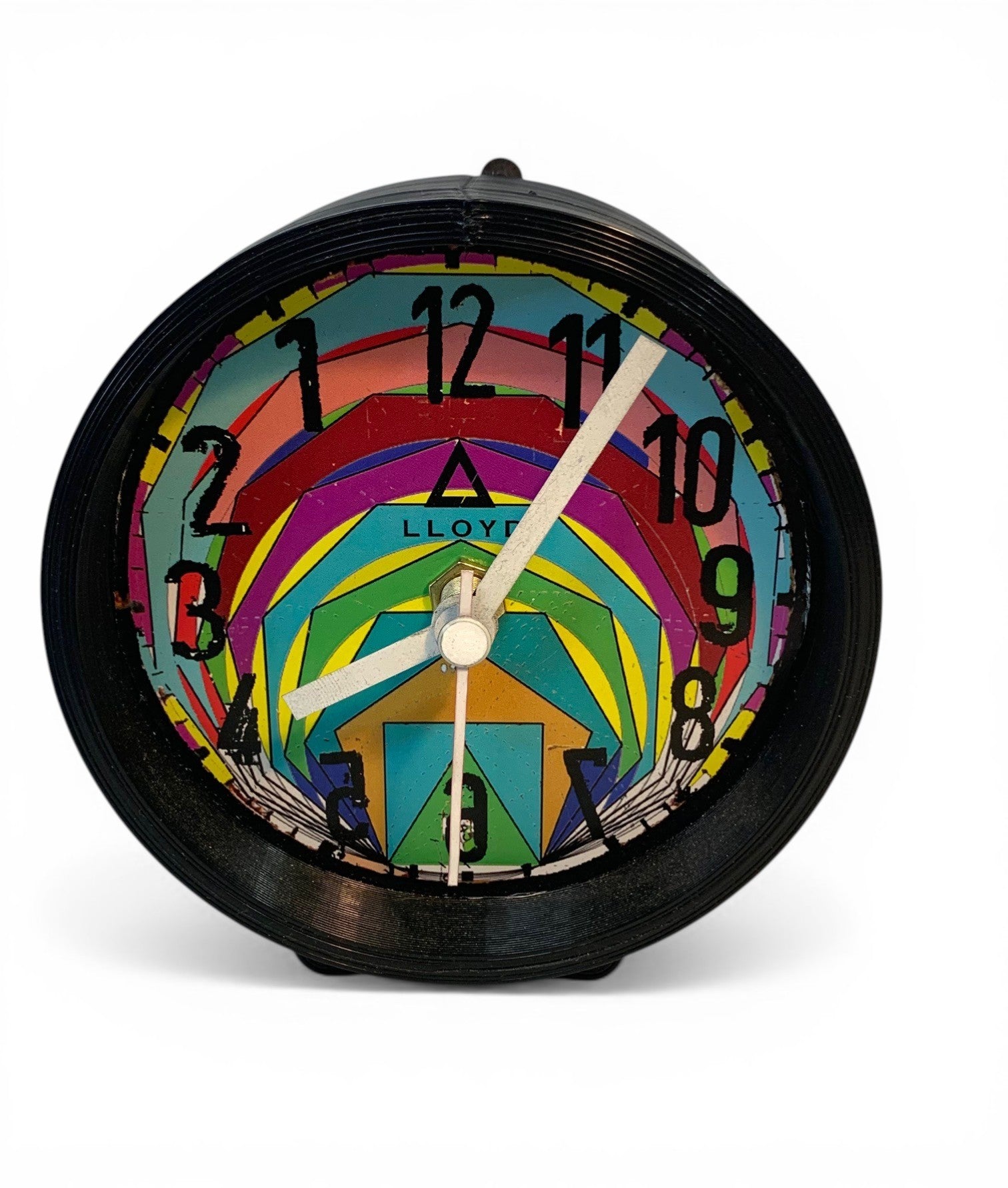 Table clock with multicolor geometric designs and reverse clock movement