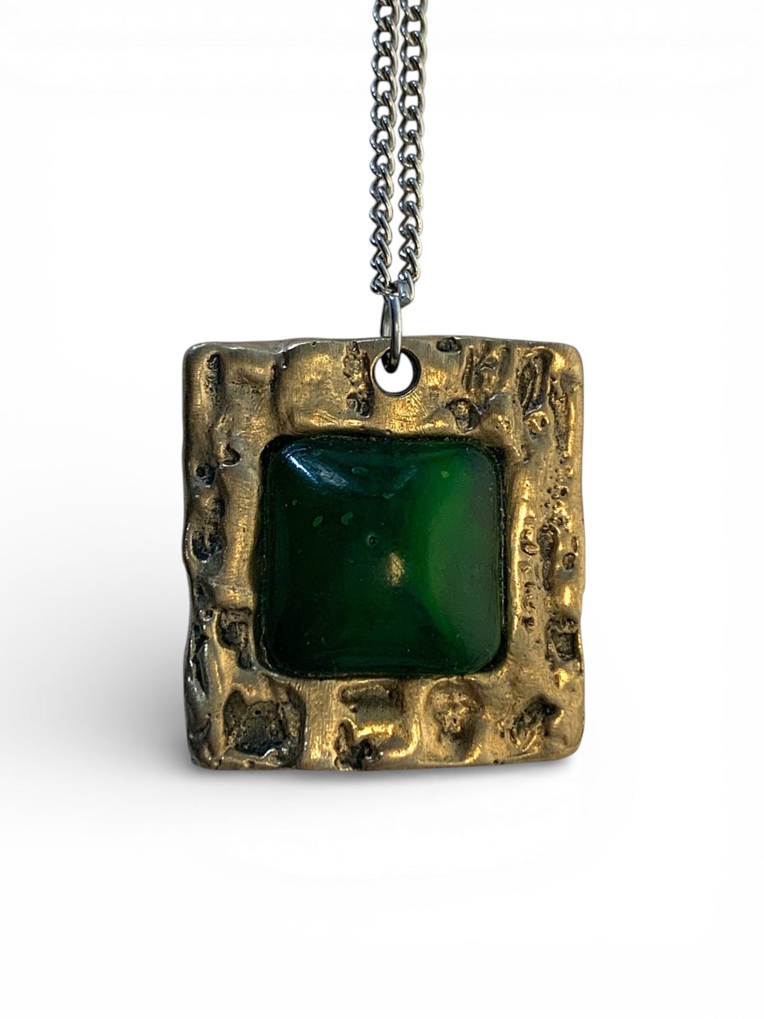 Bronze pendant with jade stone insert and polish finishing.