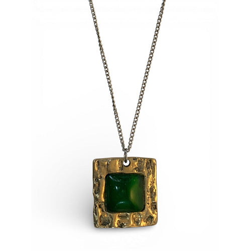 Bronze pendant with jade stone insert and polish finishing.