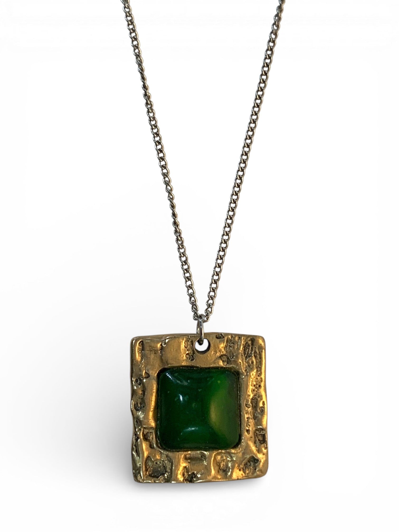 Bronze pendant with jade stone insert and polish finishing.
