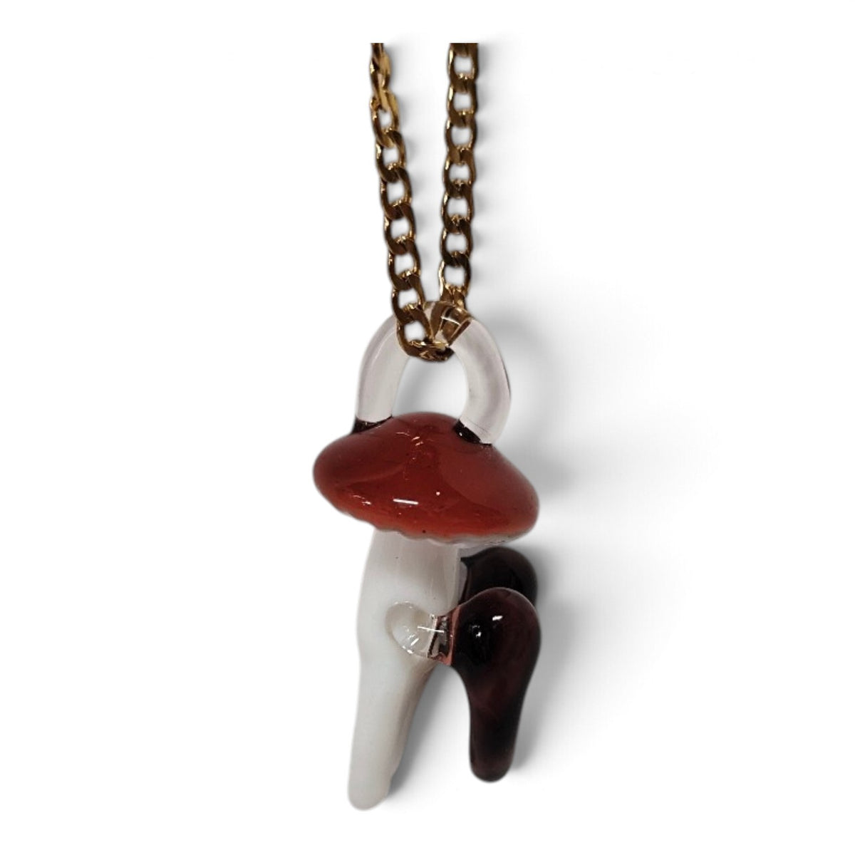 Close-up of the glass mushroom with a clear heart in its stem and a garnet heart at its side