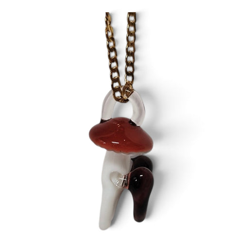 Close-up of the glass mushroom with a clear heart in its stem and a garnet heart at its side