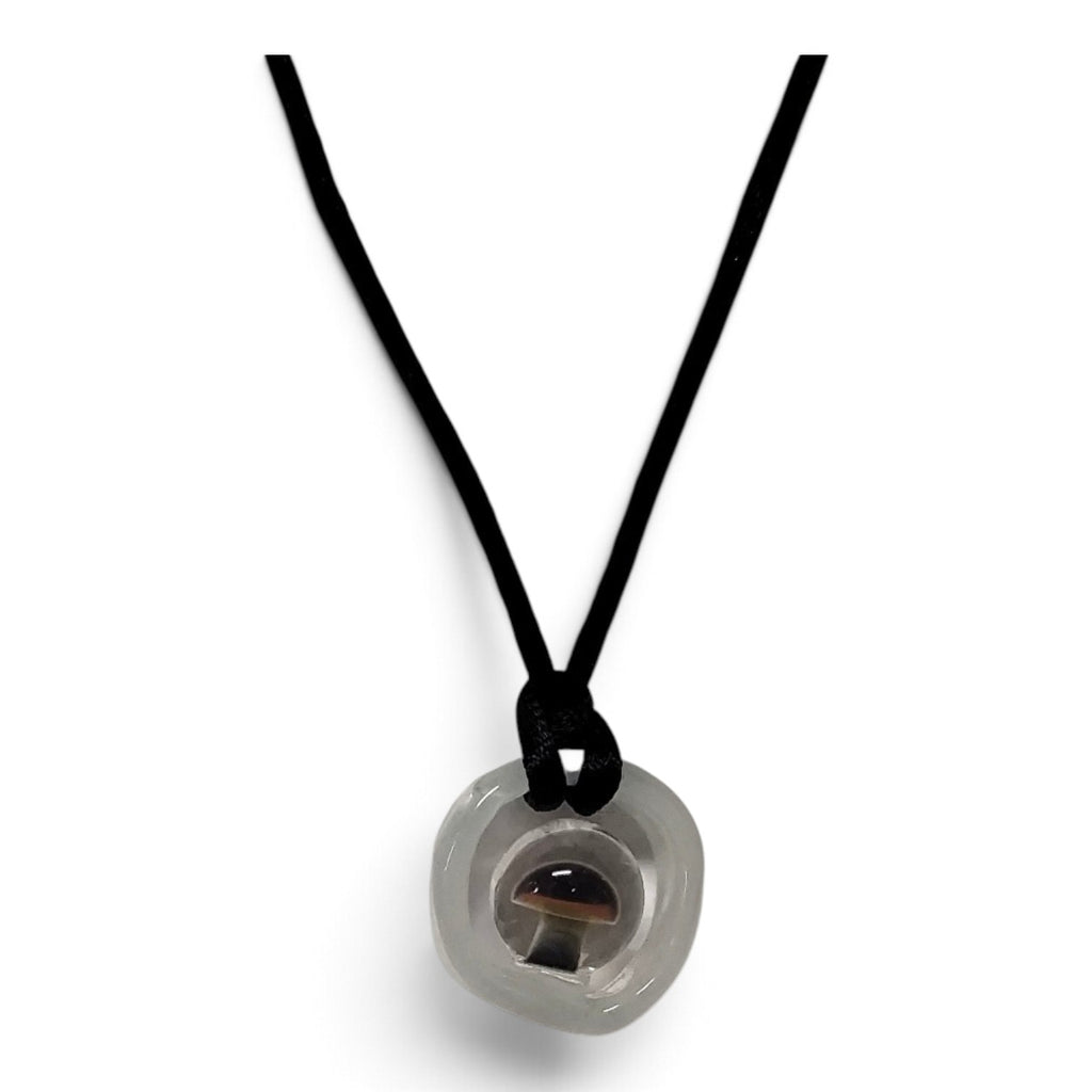 Clear borosilicate glass disc pendant with an encapsulated mushroom, on a black cord