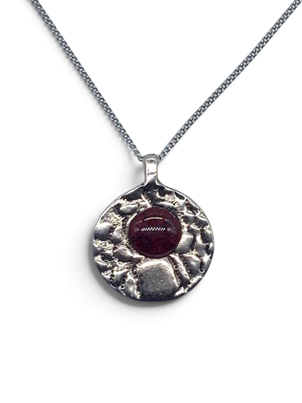 Bronze pendant with a garnet enamel inlay on a silver chain