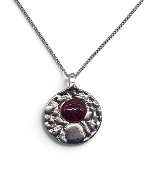 Bronze pendant with a garnet enamel inlay on a silver chain